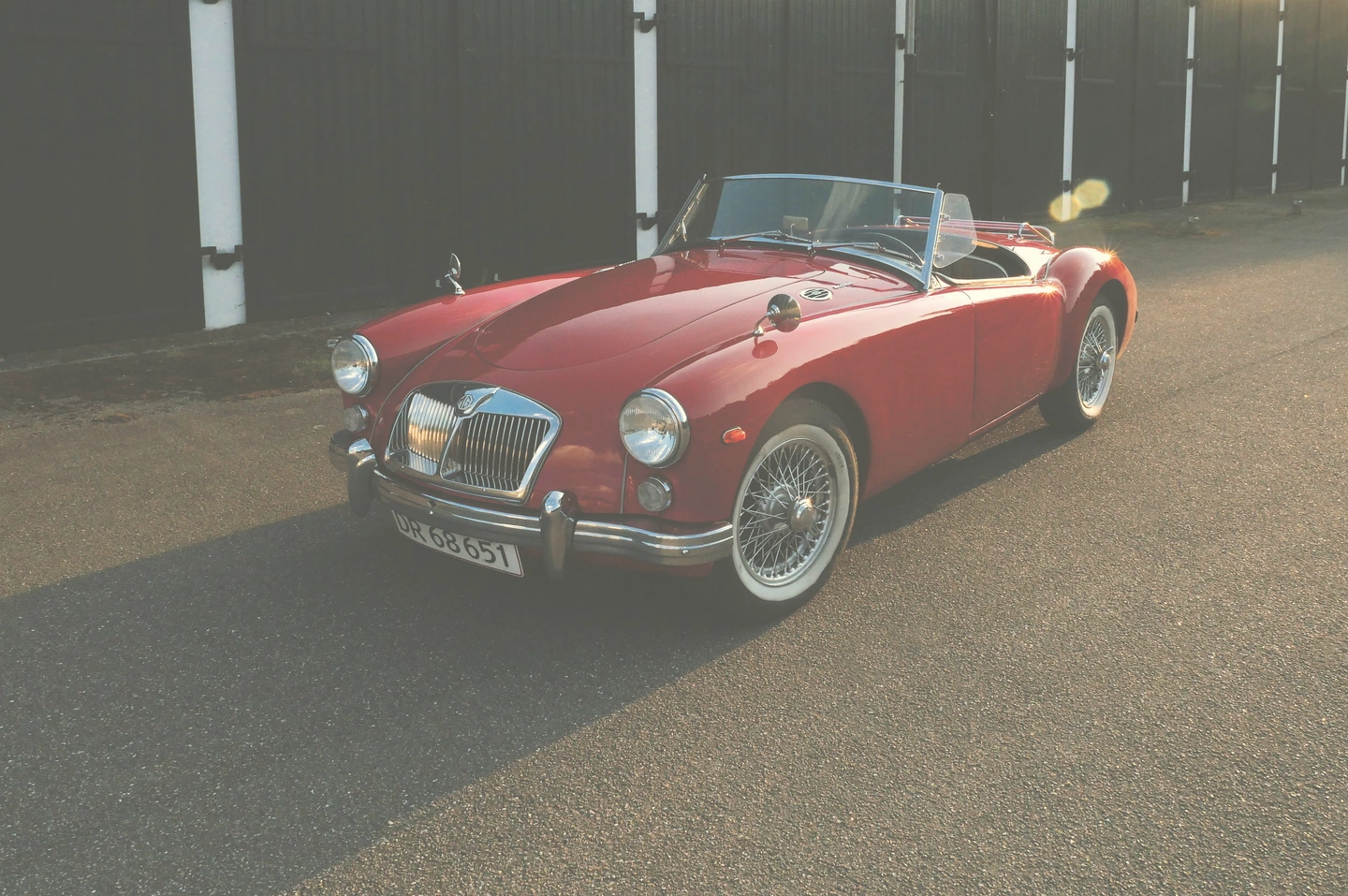 Red vintage roadster with an aged photographic colour treatment