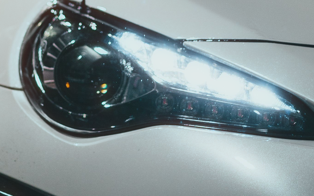 A headlight with a restrained warm fringe at Halation 35 and radius 1.2
