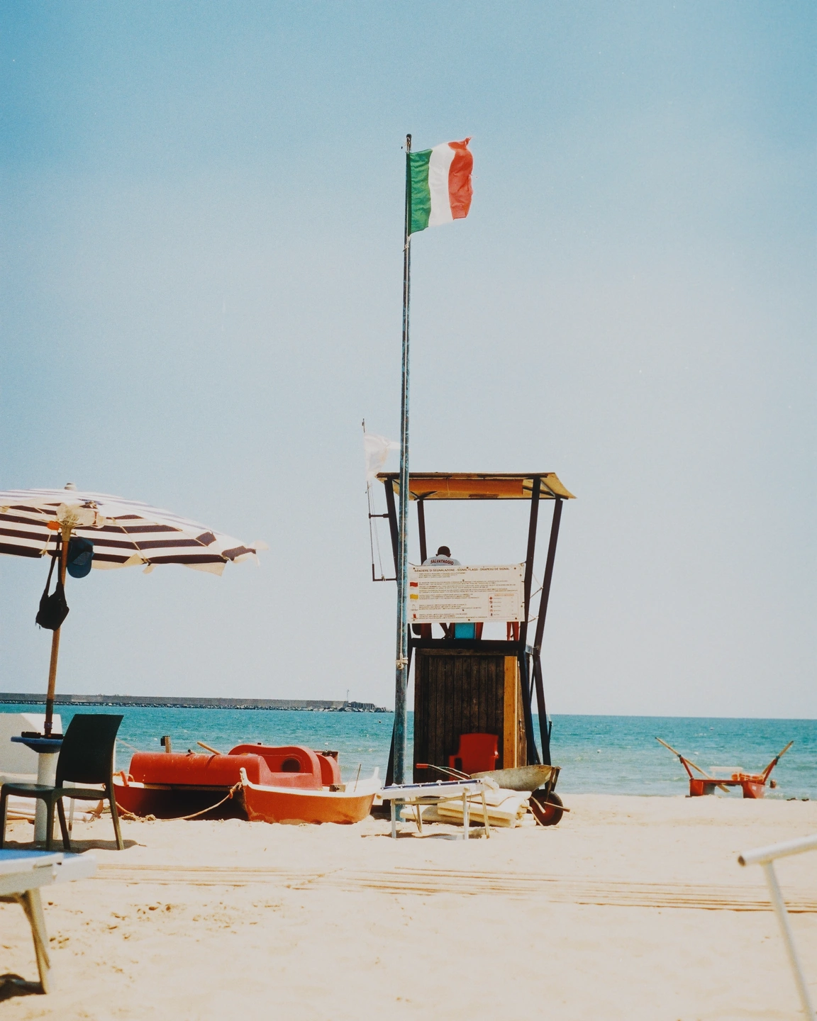 Sunlit beach with a saved-style combination of film colour, grain and light effects