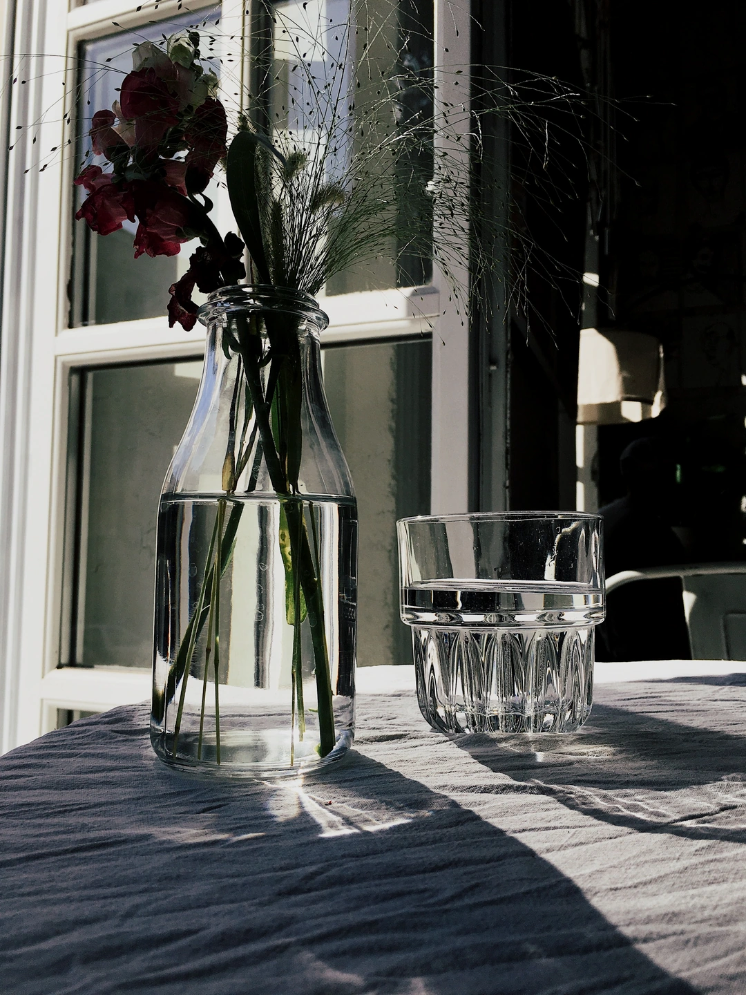 Window-lit glass and white cloth with shaped highlights and shadows